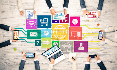 Top view of businesspeople sitting at table and using gadgets