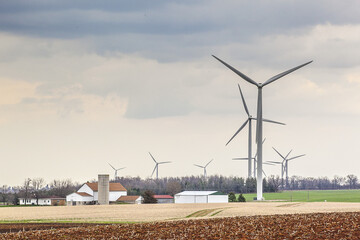 Wind turbines against a dramatic spring sky in farm country in Wisconsin.