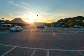 Rooftop outdoor parking lot against sunset © DarwelShots