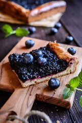 Slice of juicy homemade yeast pie with blueberry