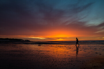 Fototapeta na wymiar Sunset at seashore with man