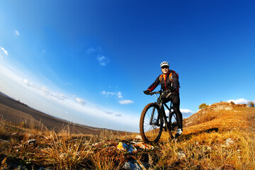 Naklejka na ściany i meble Mountain Bike and blue sky background. photographed on a fisheye lens