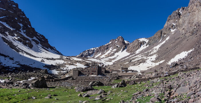 Toubkal national park in springtime with mount, cover by snow and ice, Refuge Toubkal, start point for hike to Jebel Toubkal, &ndash; highest peak of Atlas mountains and Morocco