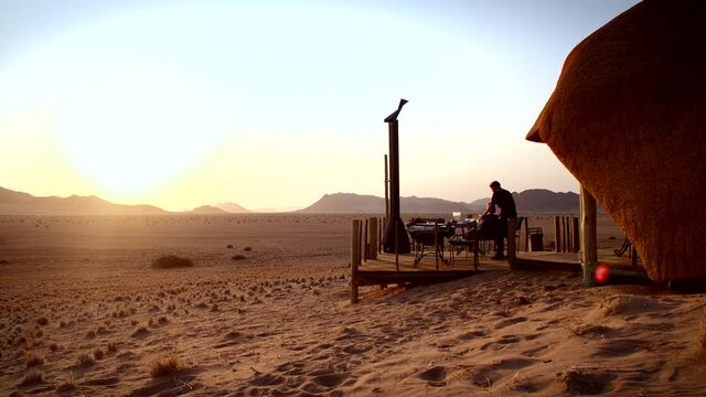 Tourists watching the desert sunset together