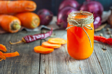 Fresh carrot juice in a glass jar
