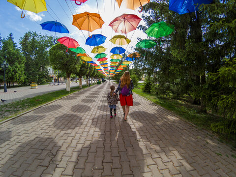  Child and mom are walking under colored umbrellas Gopro 5 black 