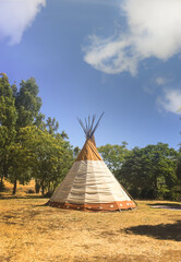 American Indian tepee or wigwam in a field