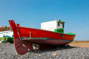 Old red fishing boat on the beach