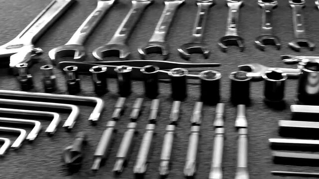 Camera on crane flying over set of hand tools laid in order close up video 
