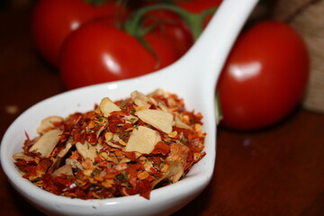 spoonful of aglione spices...blurred tomato's in background
