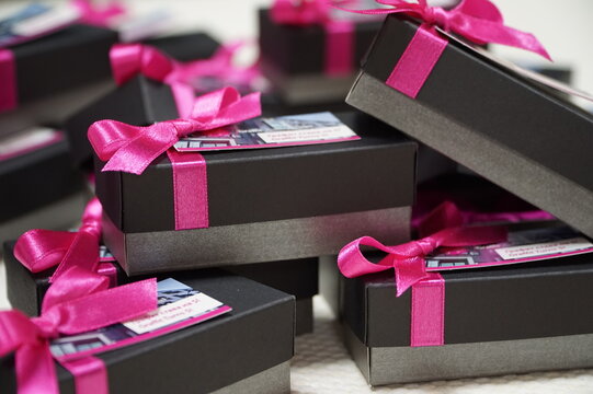 Black and grey giveaway boxes with ribbons