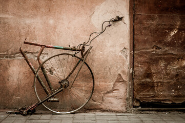 Teile eines Fahrrad an der Wand mit einem Schloss.