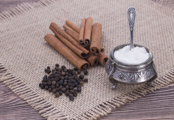 Salt, cinnamon on canvas on a wooden background