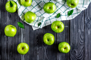 Fototapeta na wymiar ripe green apples dark wooden table background top view