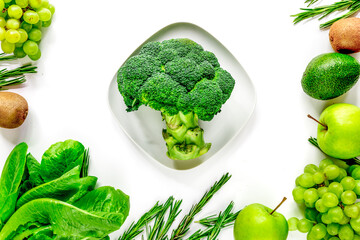 green fresh broccoli for fitness diet food on white table background top view