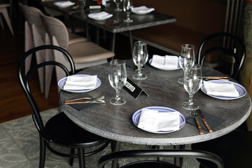 Reserved sign on restaurant table with empty dishes and glasses