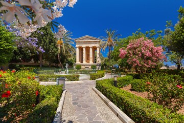 Blossoming spring Lower Barrakka Gardens and monument dedicated to Alexander Ball in the old town Valletta, capital of Malta.