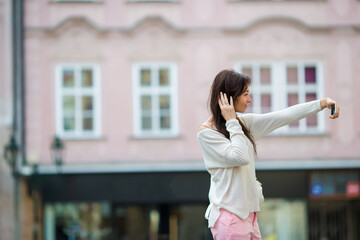 Young caucasian woman taking self portrait in european city