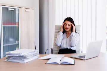 Businesswoman having headache in her office after doing very hard work