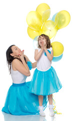 Mom and daughter with colorful balloons.