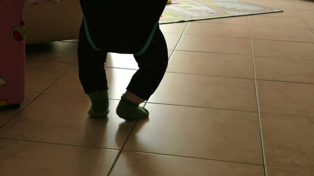 Legs Of Little Toddler Jumping In Jumper. slow-motion 96fps hd
