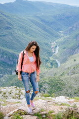 Naklejka na ściany i meble joyful woman travel mountains with backpack