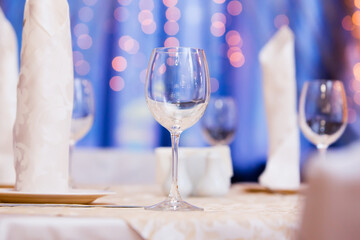 Restaurant table with glasses, napkins and cutlery