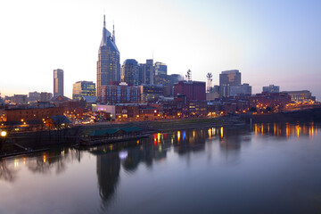 Fototapeta na wymiar Skyline of Nashville, Tennessee at sunset showing reflections in the Cumberland River