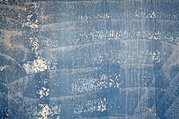 faded blue paint on corroding metal