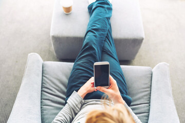 Person relaxing and using smart phone