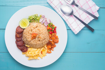 Rice Seasoned with Shrimp Paste, Thai food on white dish over wooden table.