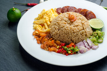 Rice Seasoned with Shrimp Paste, Thai food on white dish over dark granite table.