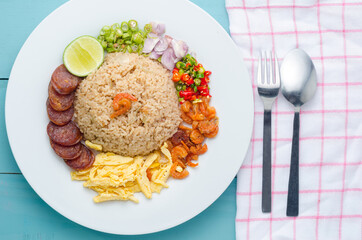 Rice Seasoned with Shrimp Paste, Thai food on white dish over dark granite table.