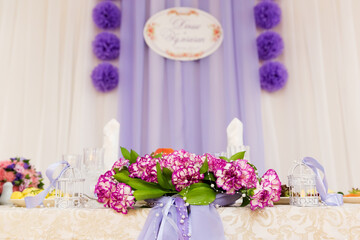 Wedding table in the restaurant with flower composition