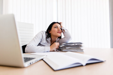 Woman at her work desk dreaming about something beautiful
