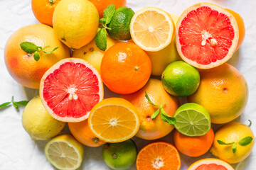 Obraz na płótnie Canvas A large assortment of colorful citrus fruit (lemon, lime, orange, grapefruit, mandarin, tangerine, pomelo)