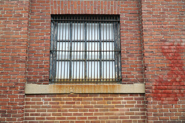 facade view of the old dirty window on the grunge brick wall