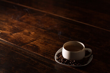 Hot coffee on the old wood.