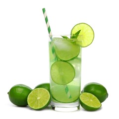 Glass of sparkling limeade with straw and limes isolated on a white background