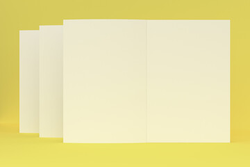 Three blank white open brochure mock-up on yellow background