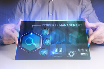 Business, Technology, Internet and network concept. Young businessman working on a virtual screen of the future and sees the inscription: Property management