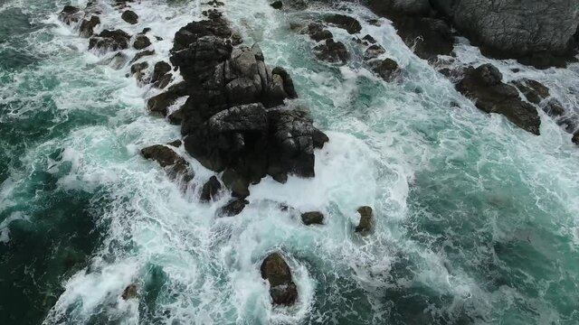 Around grey cliff rocks. Giant waves mountains. Far East marine reserve. Vladivostok unique national Park of Russia nature Primorsky Stormy dark clouds Epic cinematic aerial drone flight 4k ultrahd.