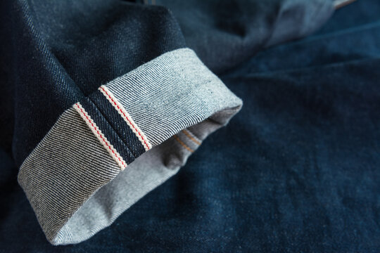 fold hem of red selvedge japan dark blue jeans vintage style denim, close up