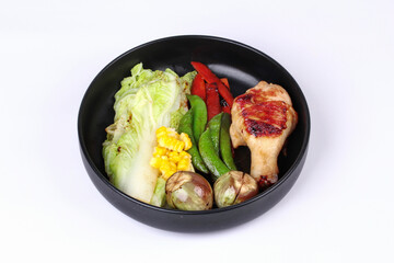 Chicken drumstick steak and grilled mixed vegetables .