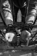 Fototapeta na wymiar Prisoner's hands in chains
