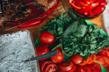 Fresh vegetables on a plate. Tomatoes and herbs