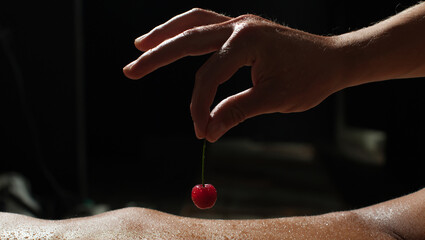 Sexy couple. Cherry summer fruit. Sexy erotic game. Bdsm  - obrazy, fototapety, plakaty