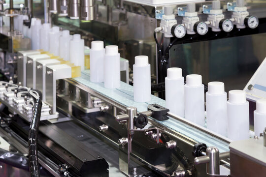 White Plastic Bottle On Factory Line Machine In The Factory, Selective Focus.