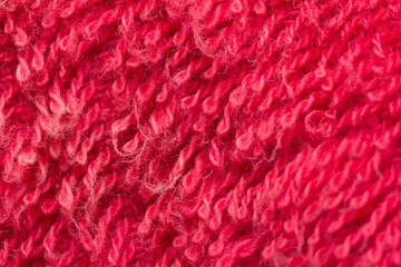 Red fabric textile background wallpaper. Close up super macro zoom.