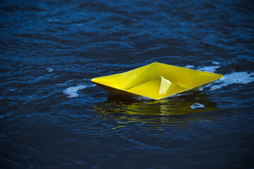 Lonely yellow paper boat
